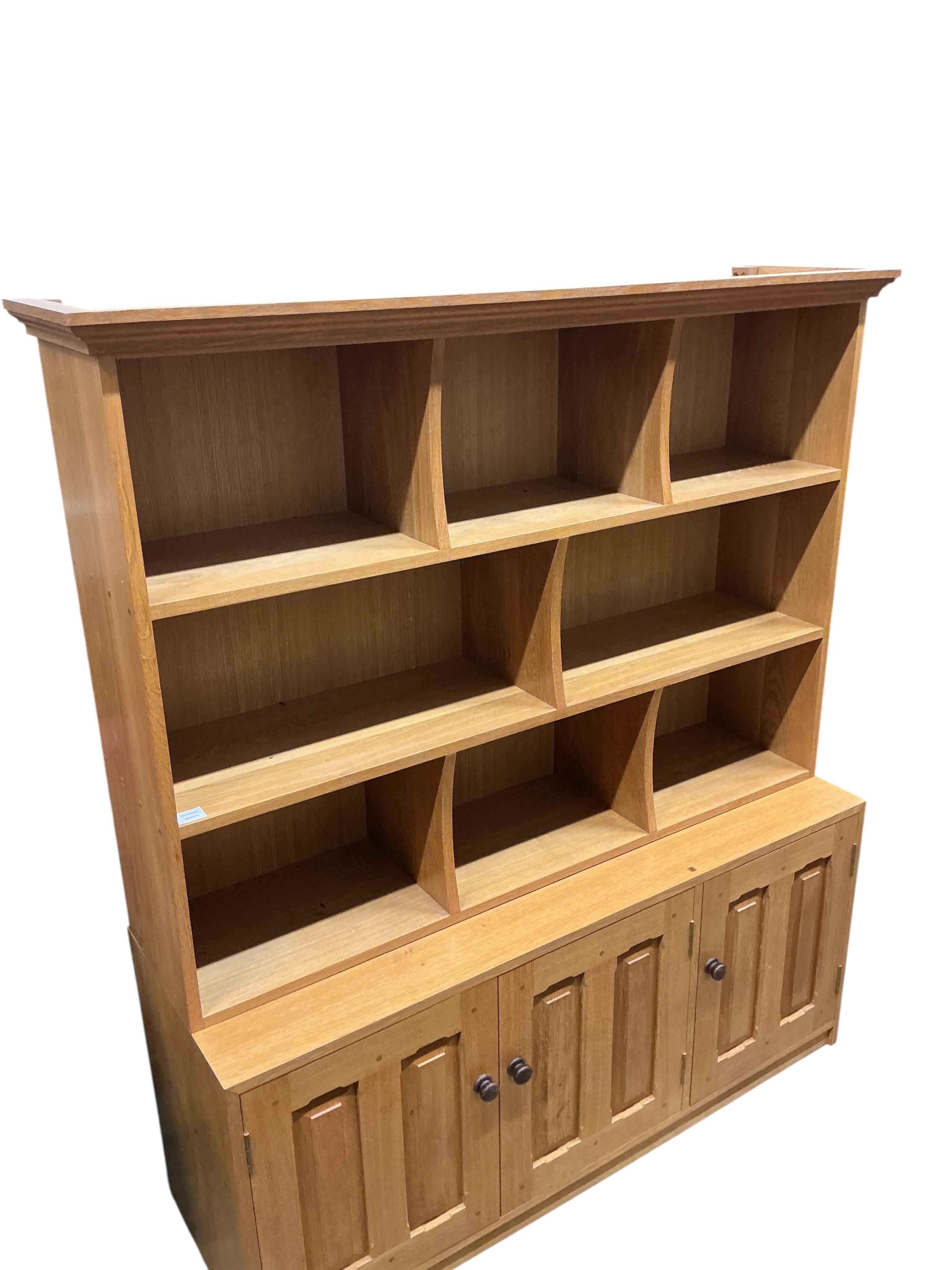 A Contemporary bespoke oak open bookcase, cupboards below, width 141cm, depth 46cm, height 169cm